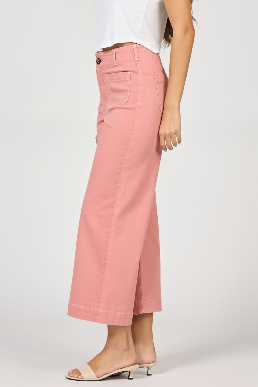 Person wearing pink pants on a white background