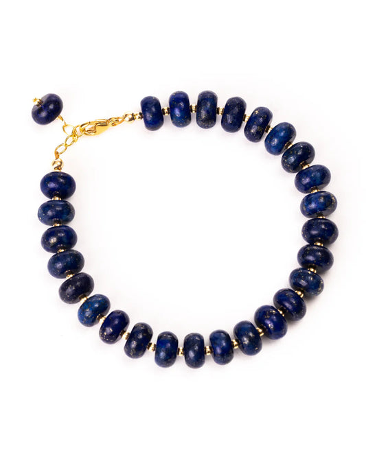 Blue beaded bracelet with gold clasp on a white background