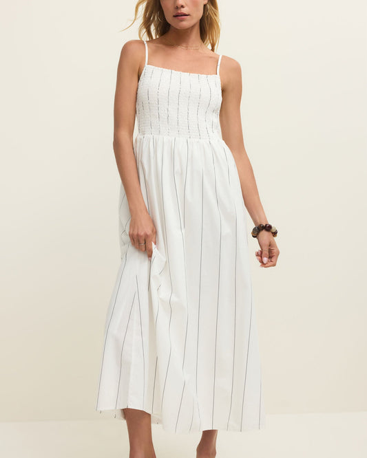 Woman wearing a white dress against a plain background