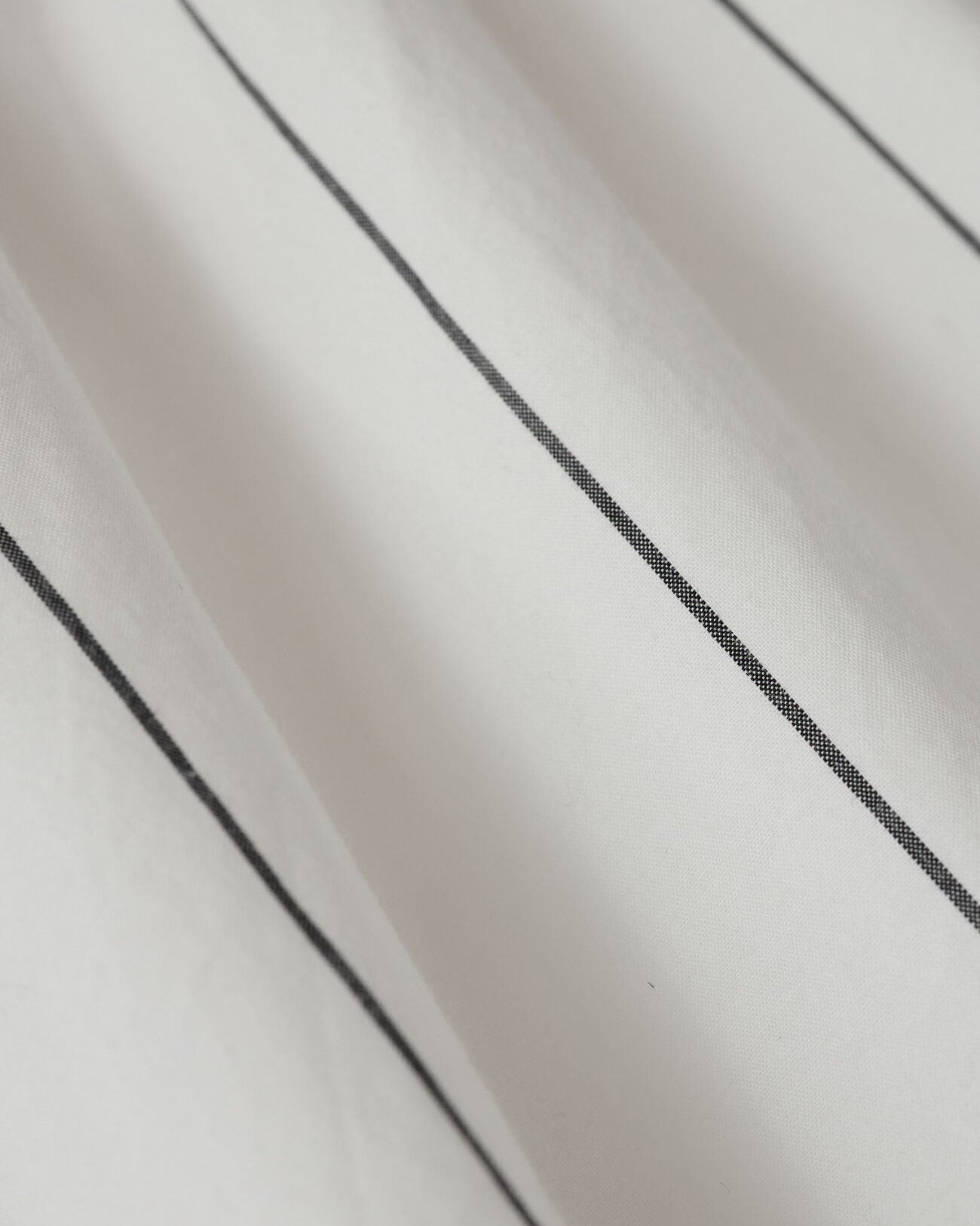 Close-up of a textured white surface with black lines