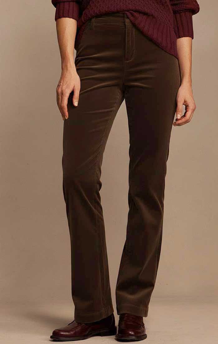 A person wearing dark brown straight-leg corduroy trousers, a burgundy knit sweater, and dark brown leather shoes, standing against a plain beige studio background.
