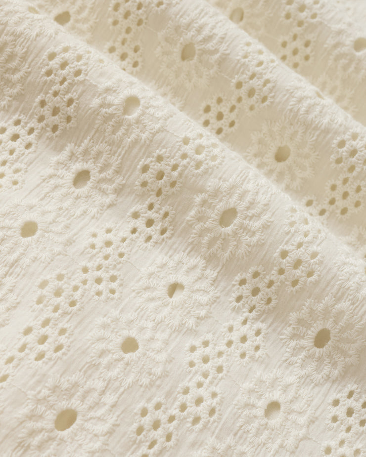 Close-up of textured beige fabric with a subtle pattern