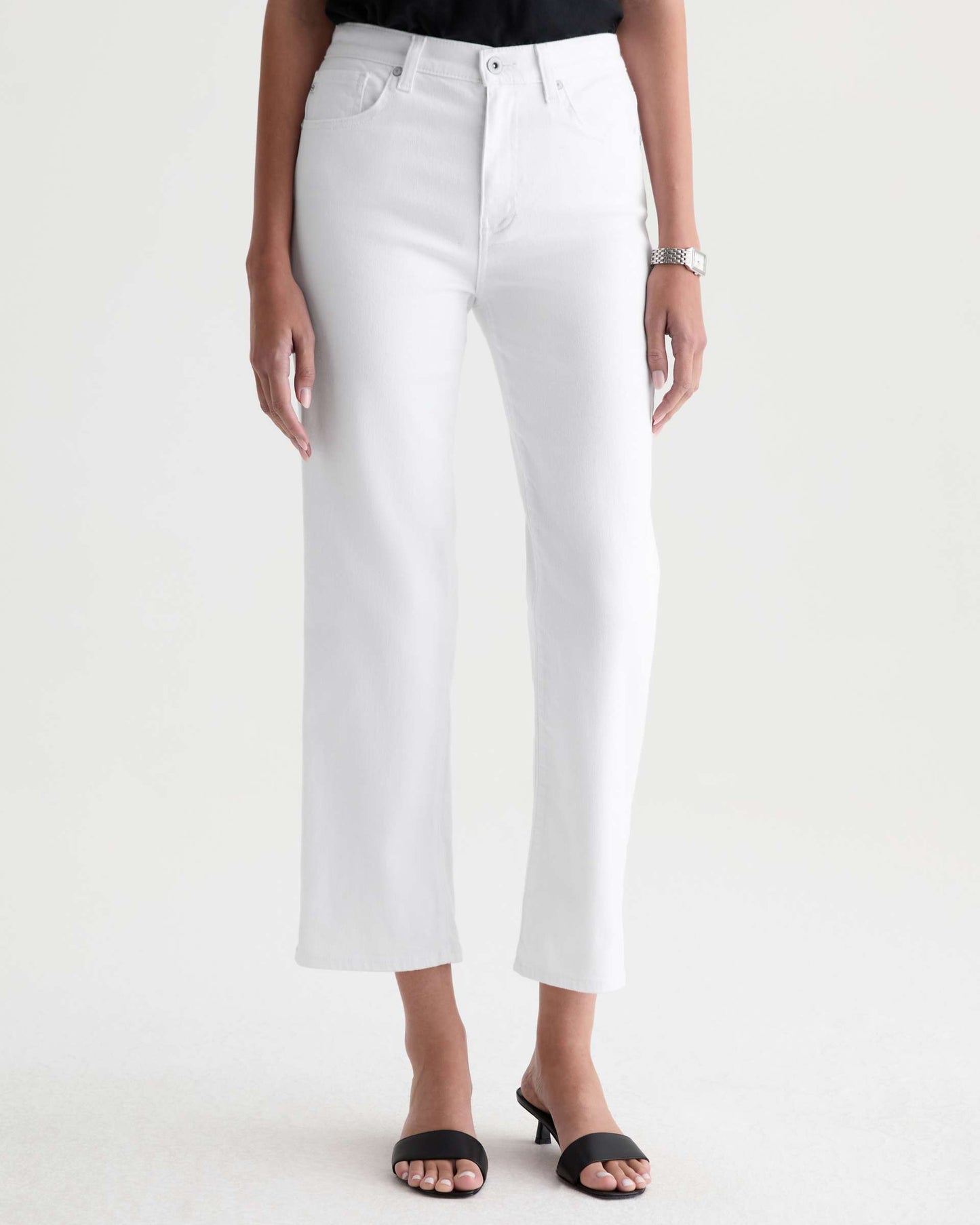 Person wearing white pants on a plain background
