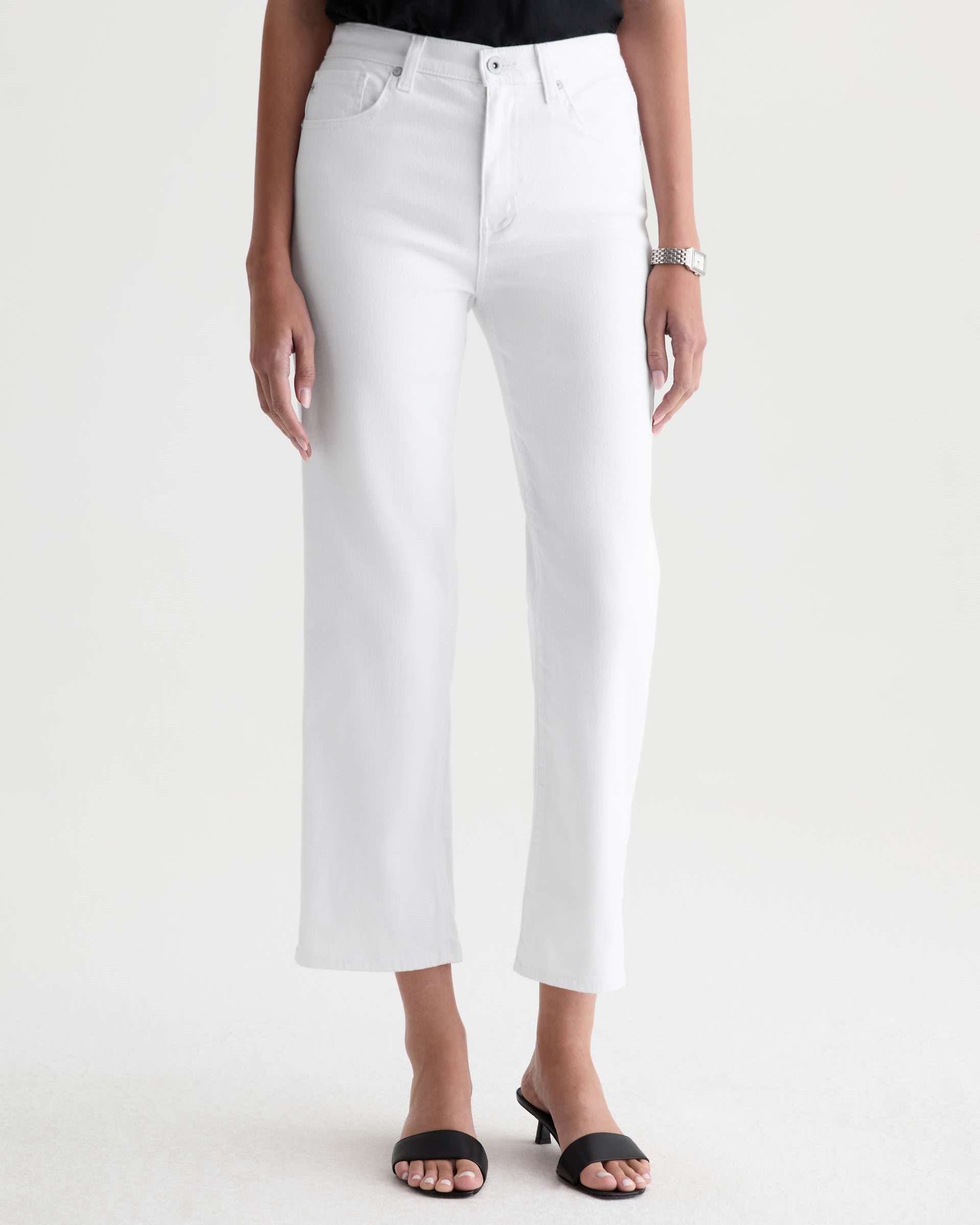Person wearing white pants on a plain background