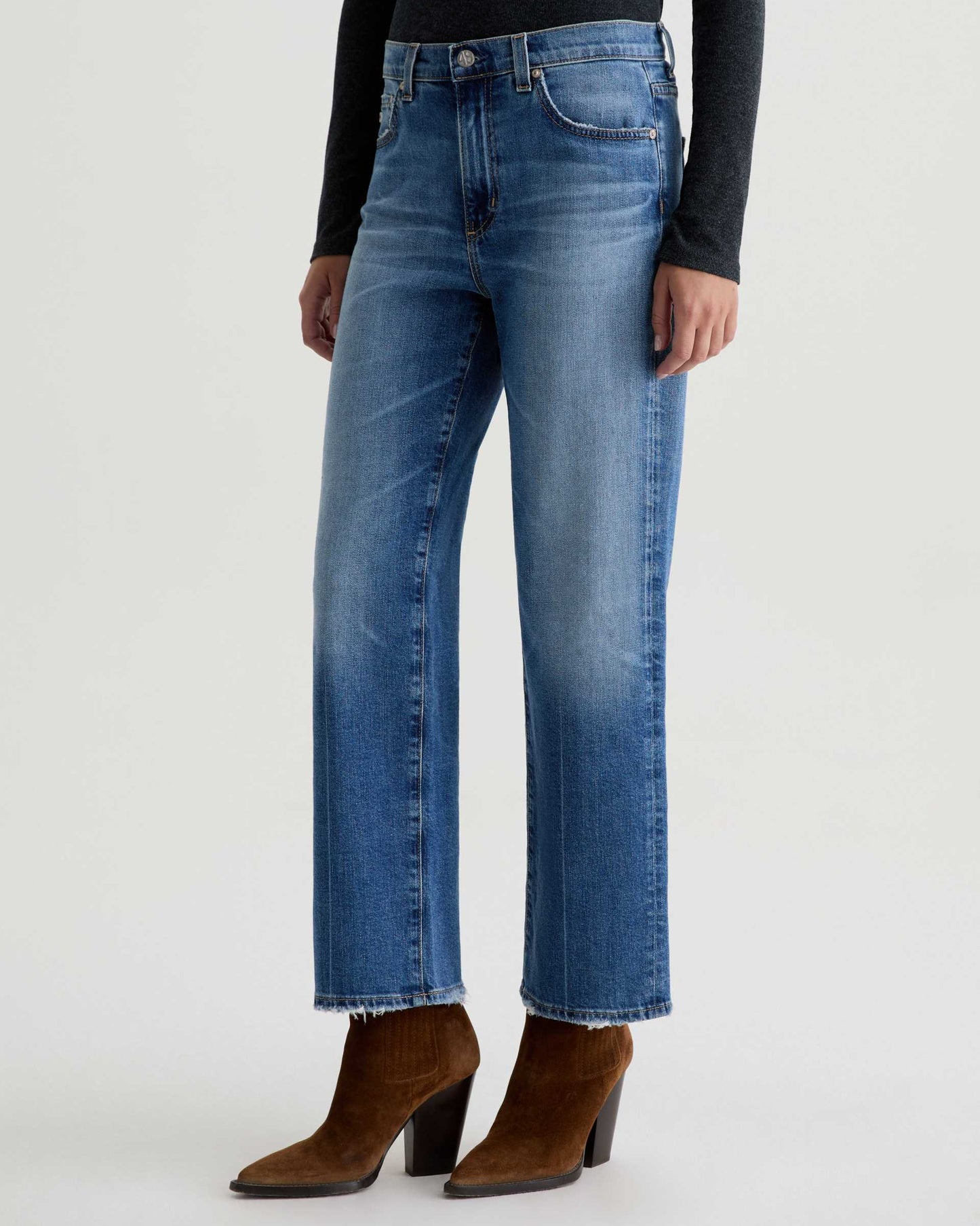 Blue jeans worn by a person on a white background