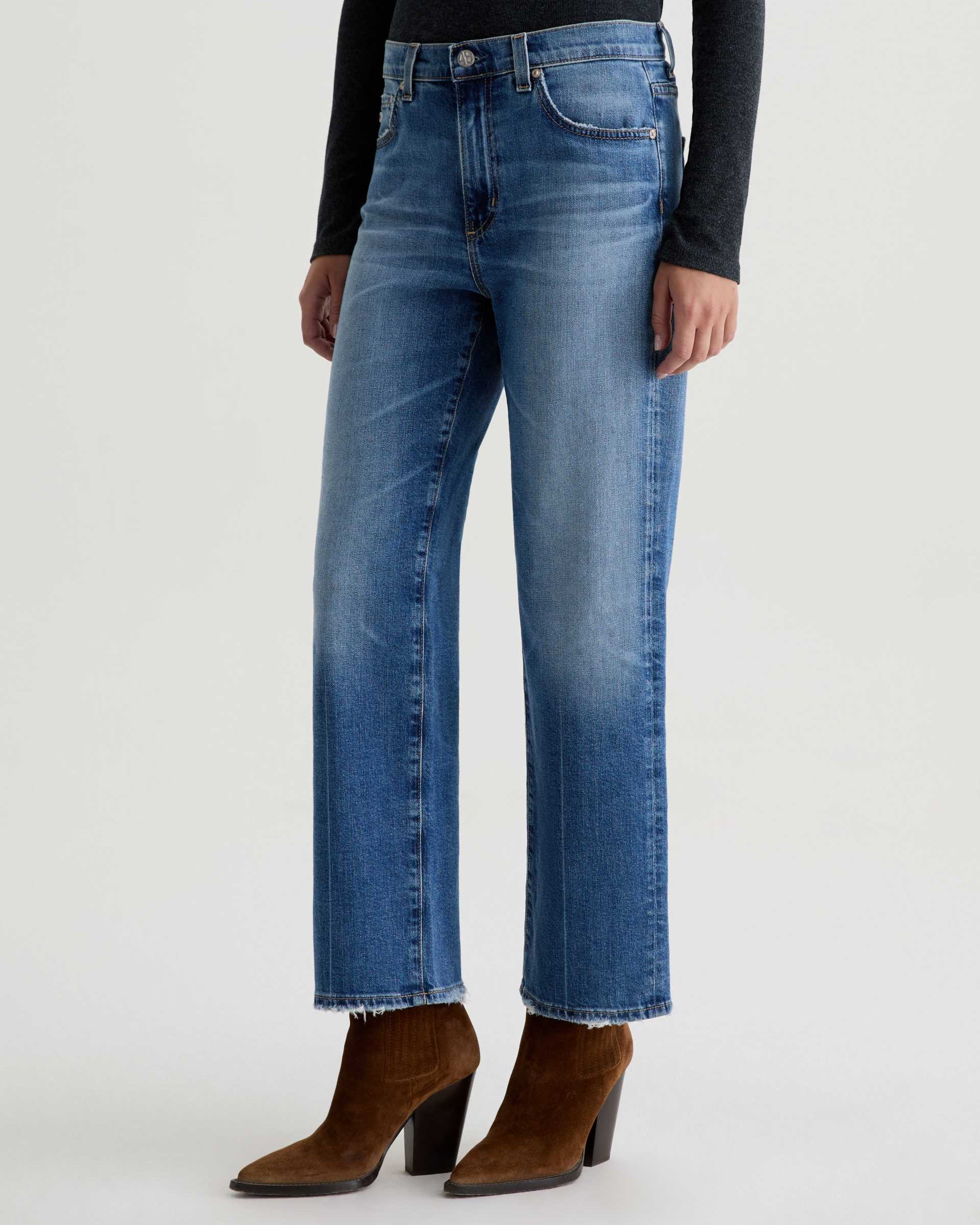 Blue jeans worn by a person on a white background