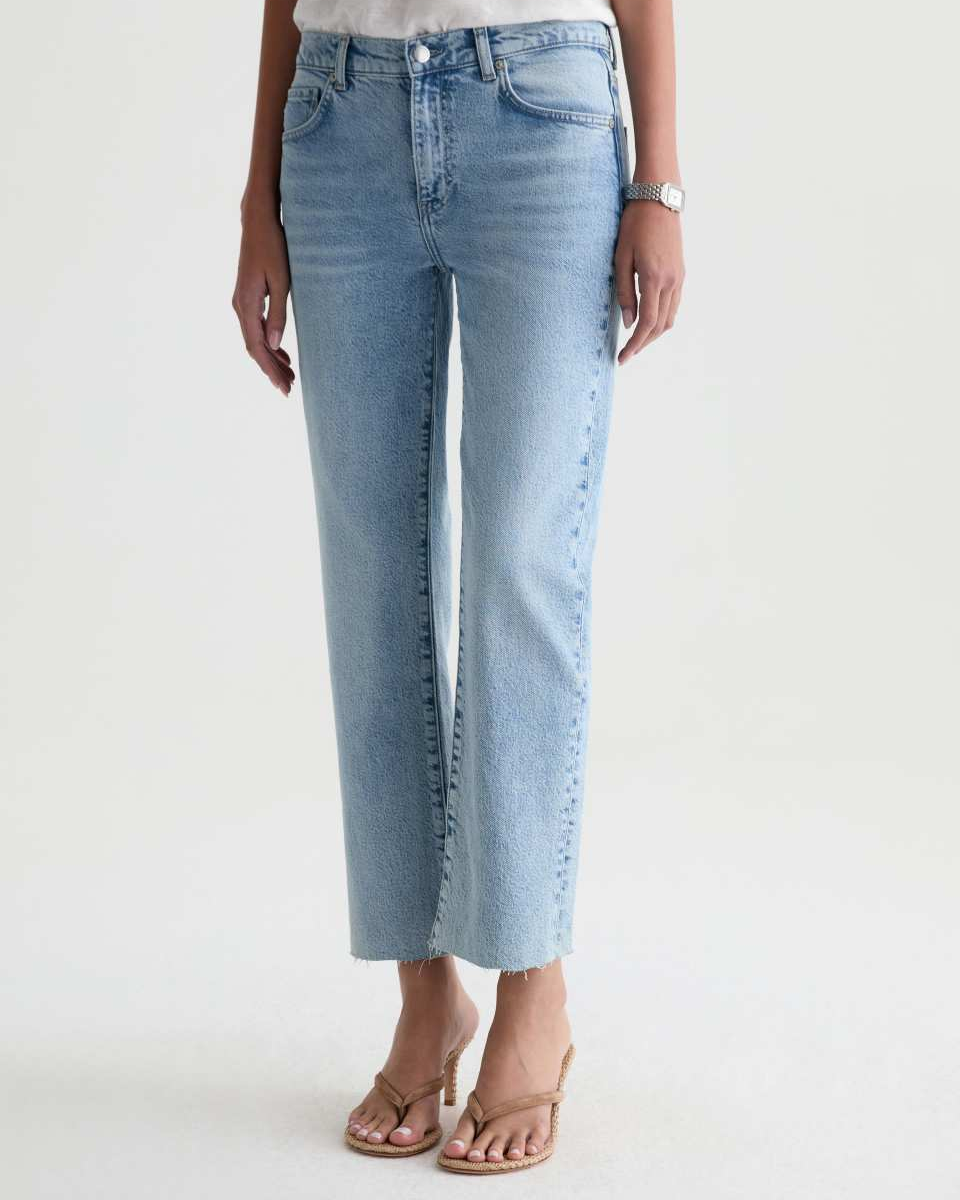 Light blue jeans worn by a person on a white background