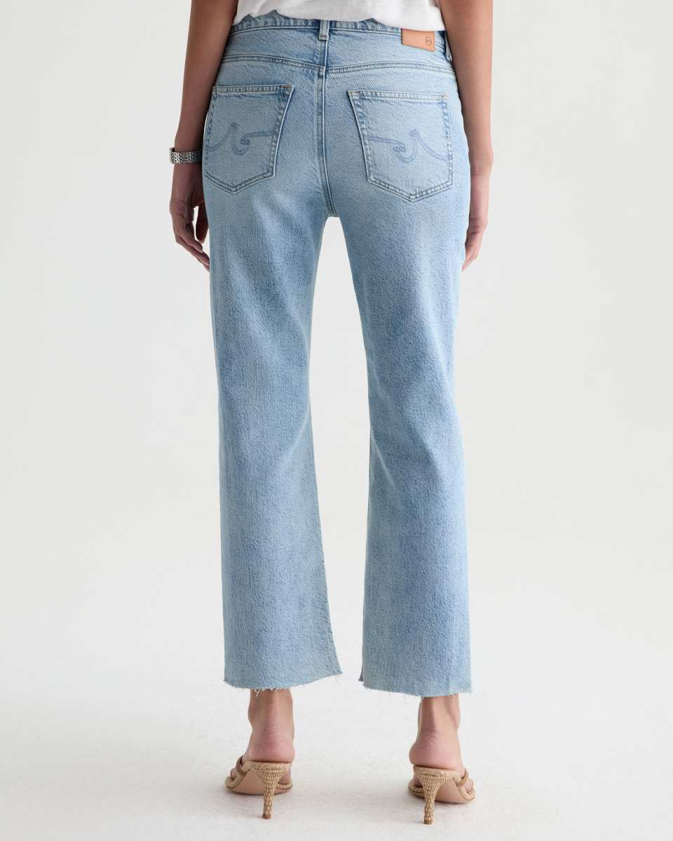 Light blue jeans worn by a person on a white background