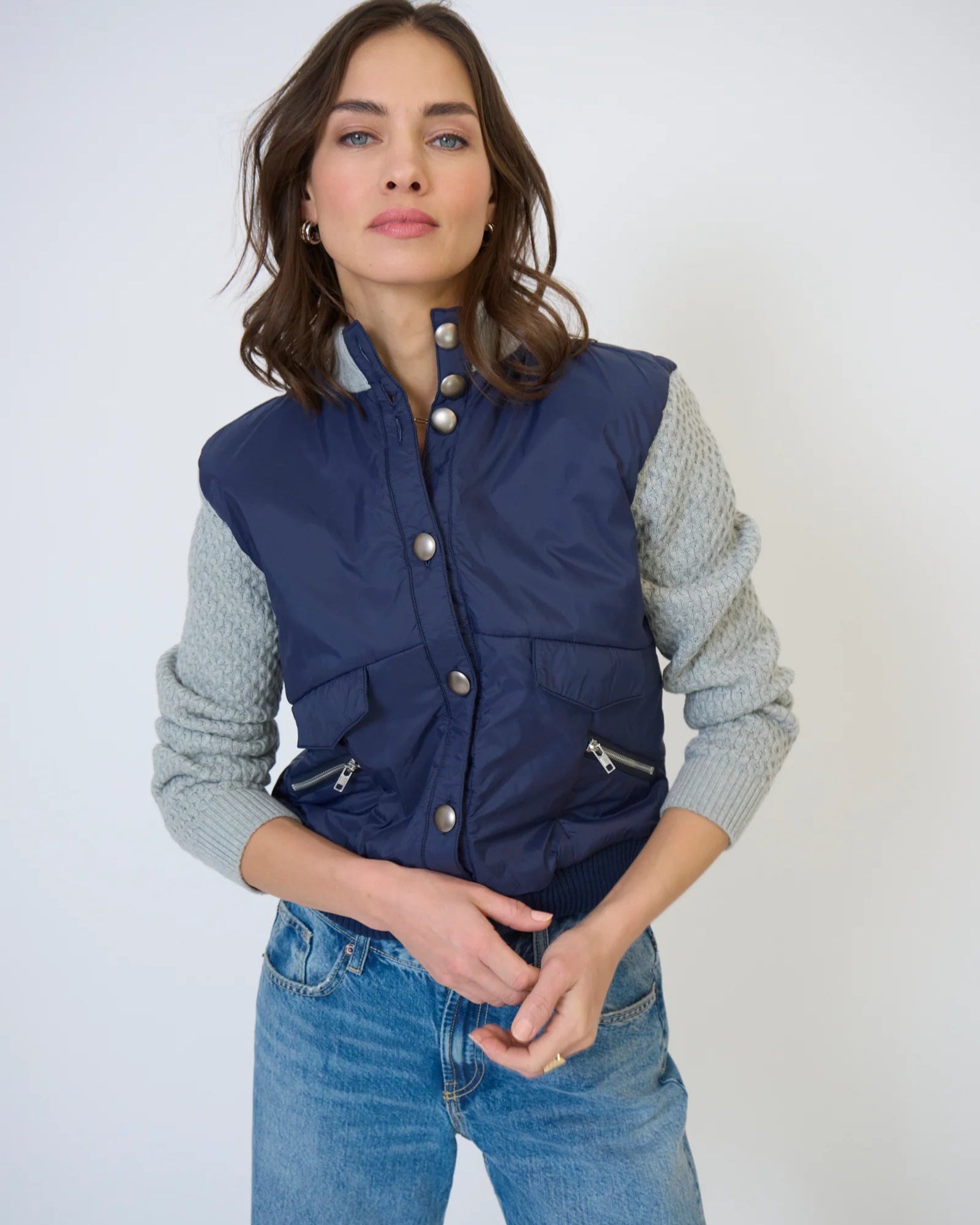 Model is wearing Central Park West Brady Quilted Mixed Media Jacket in Navy on a white background. 