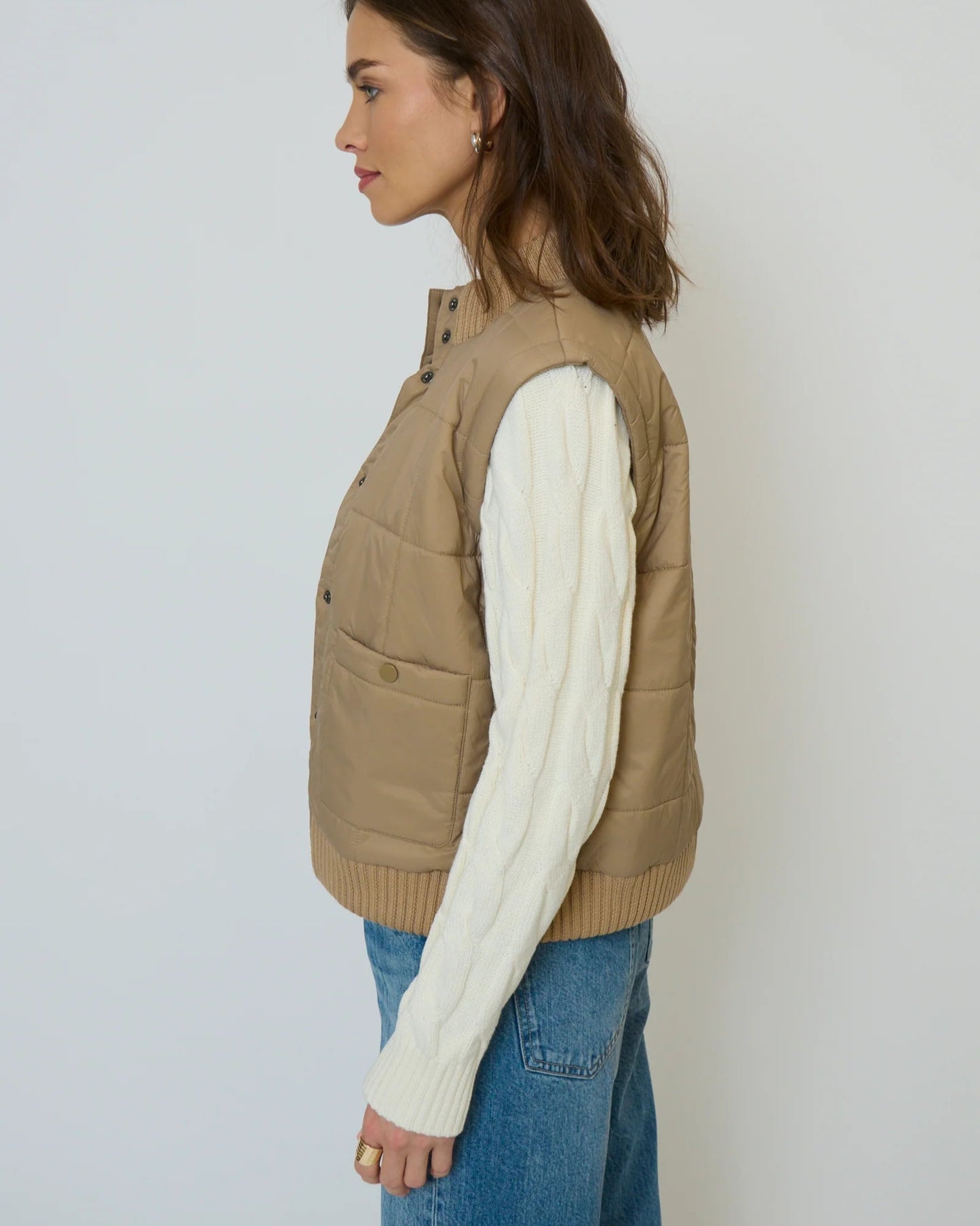 Side view of model wearing Central Park West Brady Quilted Mixed Media Jacket in Oat on a white background