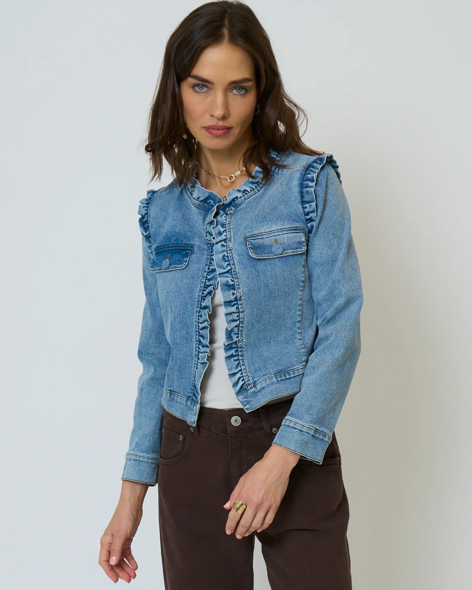 Woman wearing a denim jacket against a plain background