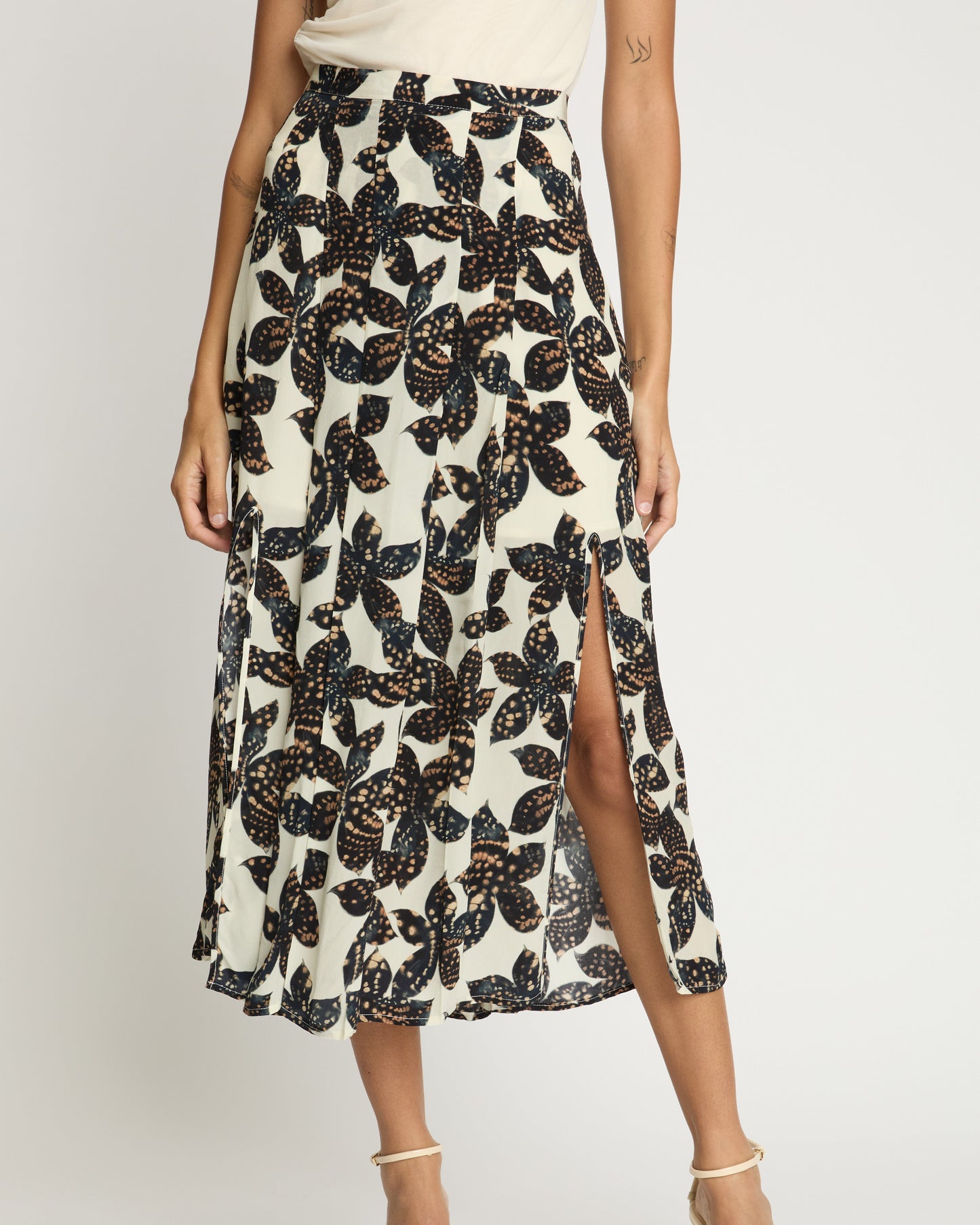 Woman wearing a floral patterned skirt with a white background