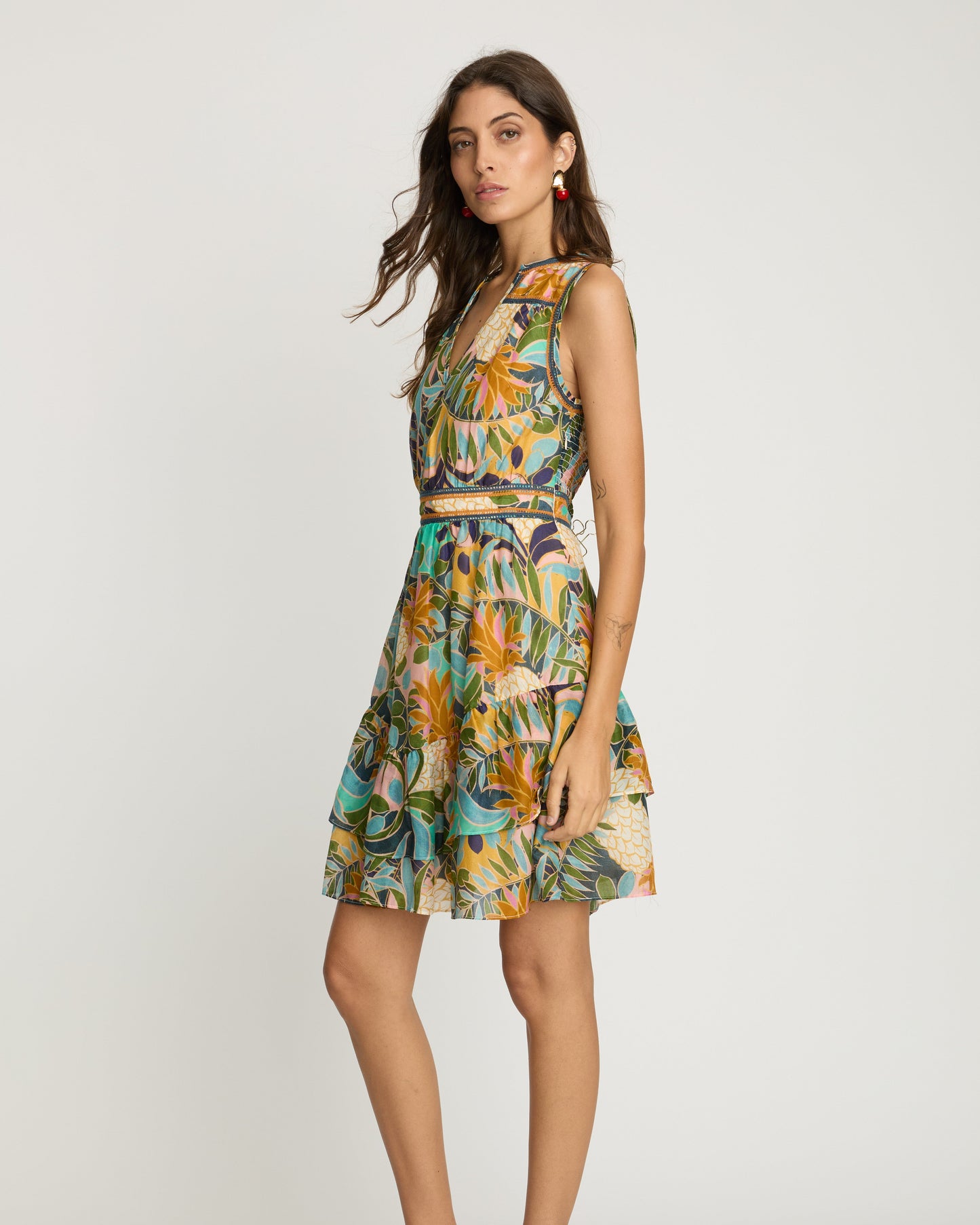 Woman wearing a colorful floral dress on a white background