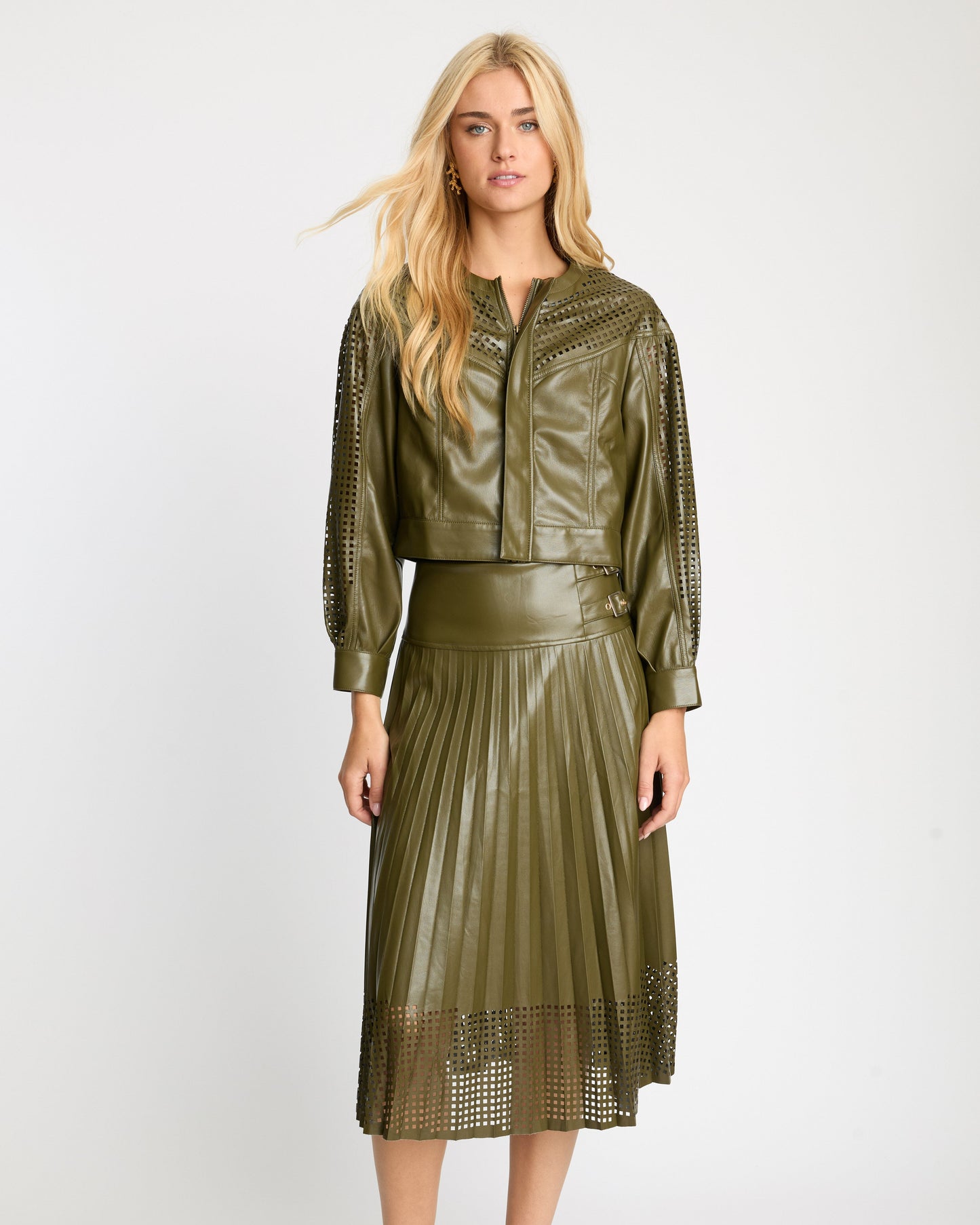 Woman wearing a green leather outfit on a white background