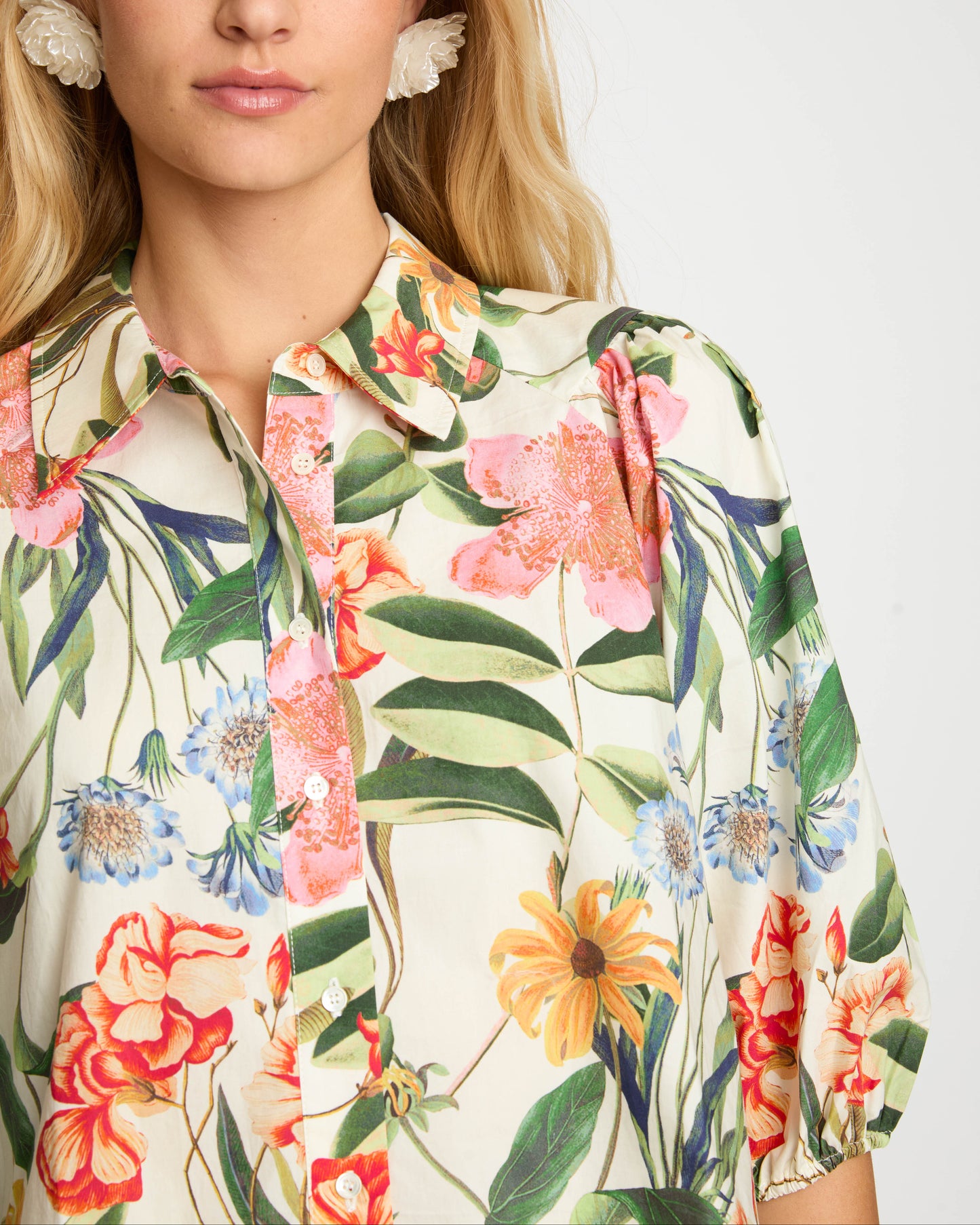 Woman wearing a floral blouse with a white background