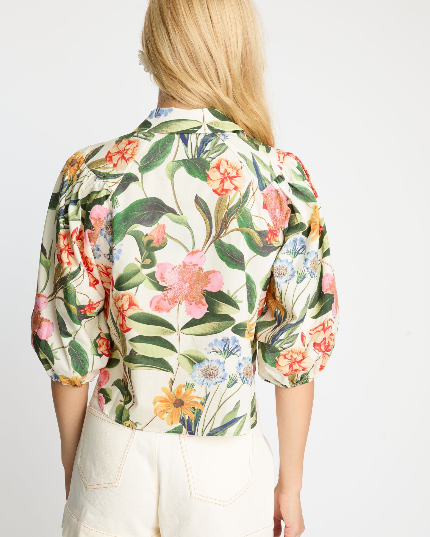 Person wearing a floral shirt with a white background
