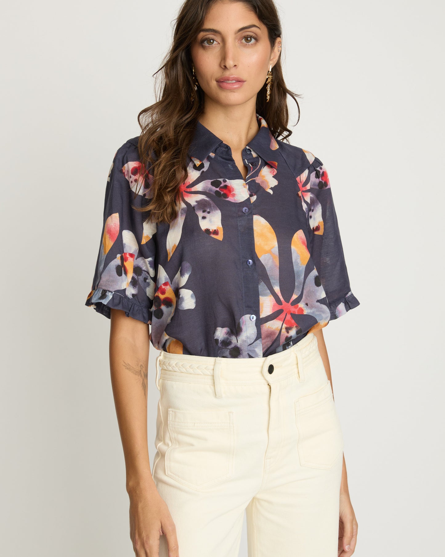 Woman wearing a floral blouse with a plain background
