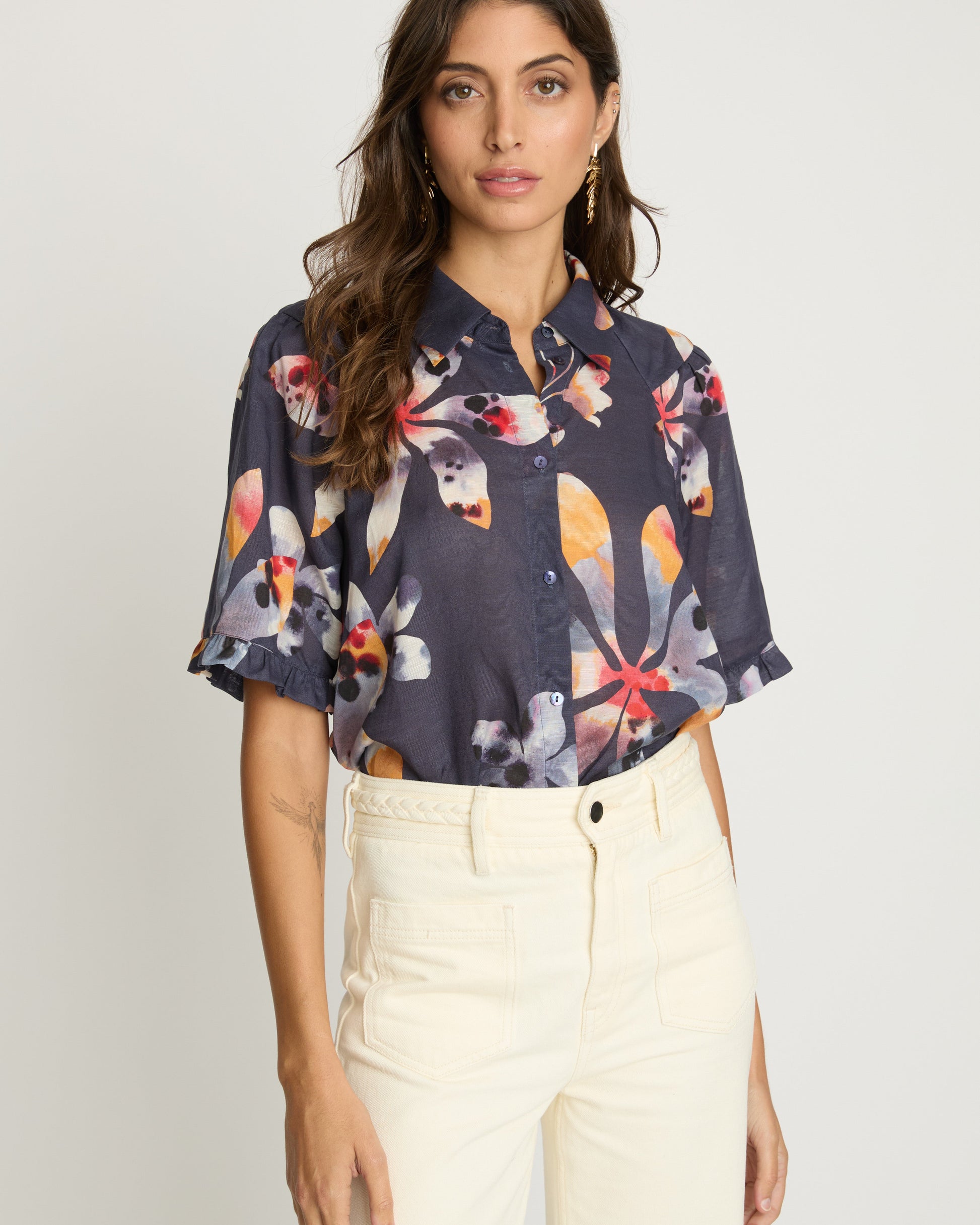Woman wearing a floral blouse with a plain background