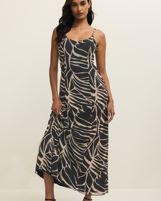 Woman wearing a black and beige patterned dress on a white background