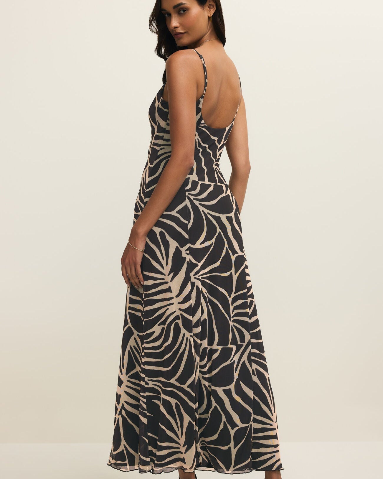 Woman wearing a patterned dress on a white background
