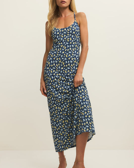 Woman wearing a blue floral dress on a white background