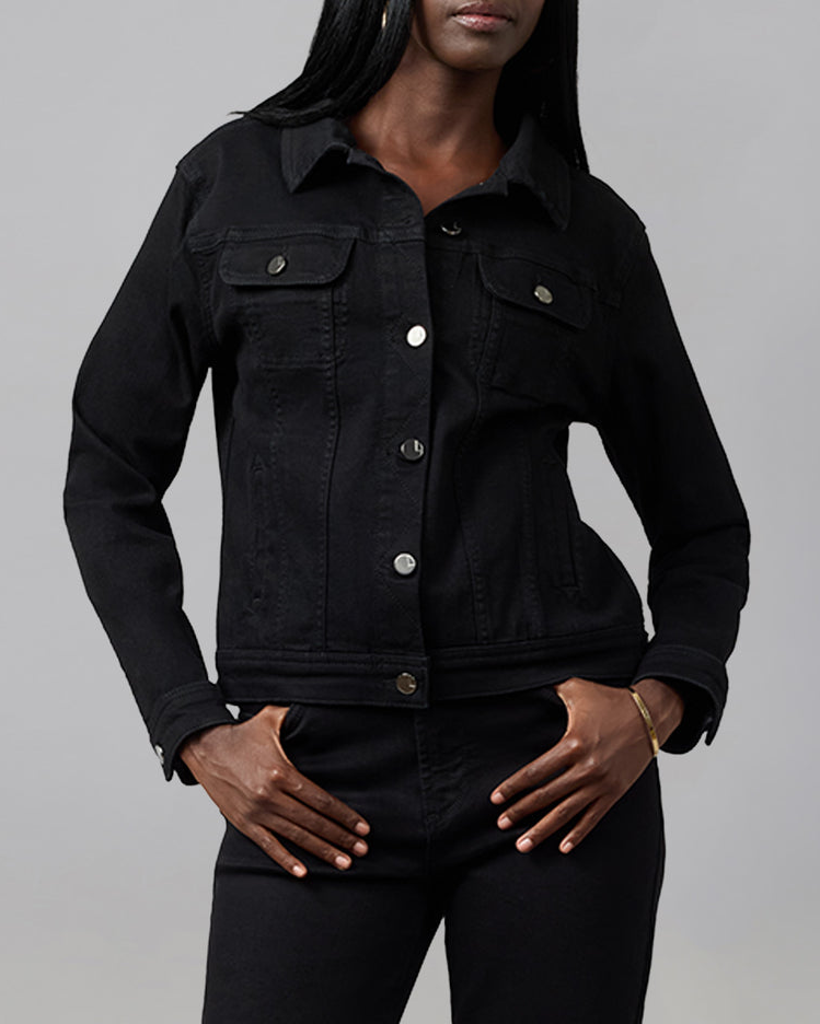 Person wearing a black denim jacket on a gray background
