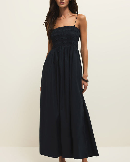 Woman wearing a black strapless dress on a white background