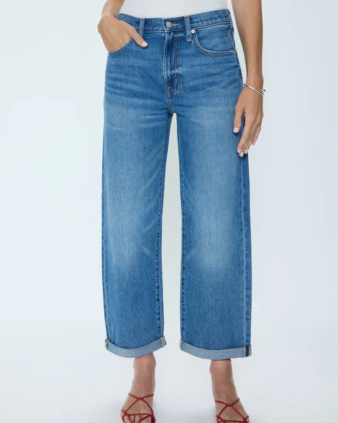 Person wearing blue jeans on a white background