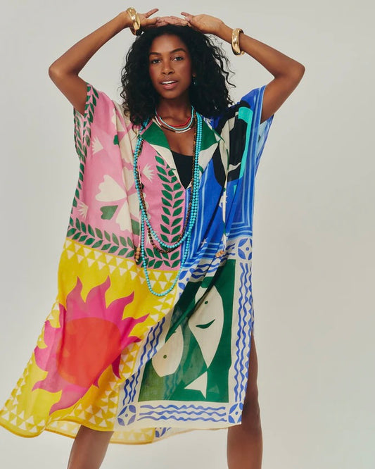 Woman wearing a colorful patterned dress with a white background