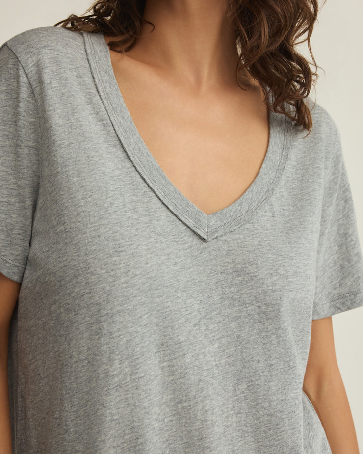 Gray t-shirt worn by a person with a neutral background