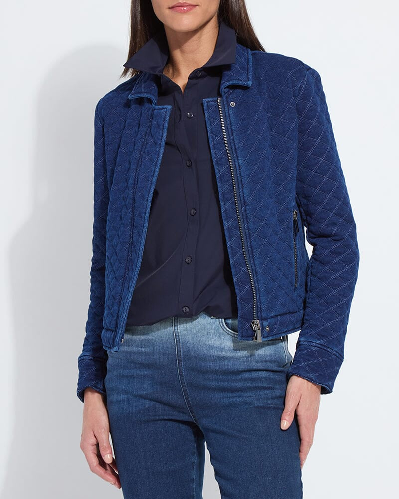 Person wearing a blue quilted jacket and jeans on a white background