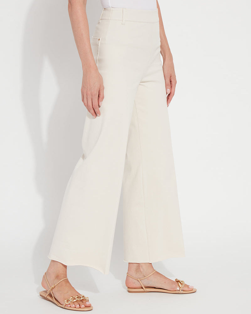 Person wearing white wide-leg pants on a plain background