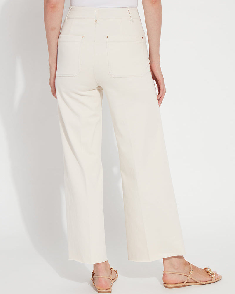 Person wearing white pants on a plain background