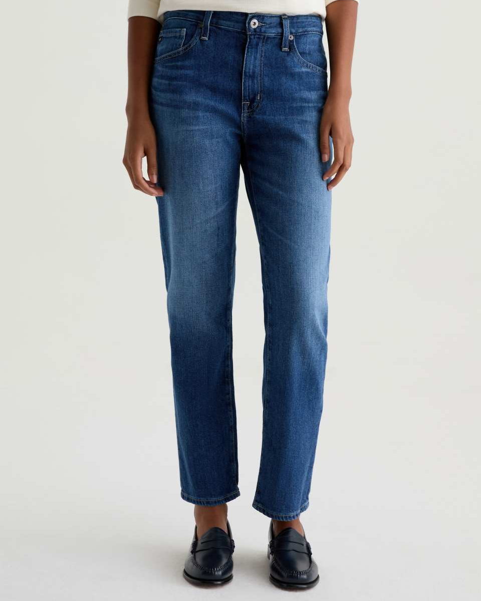 Person wearing blue jeans on a white background