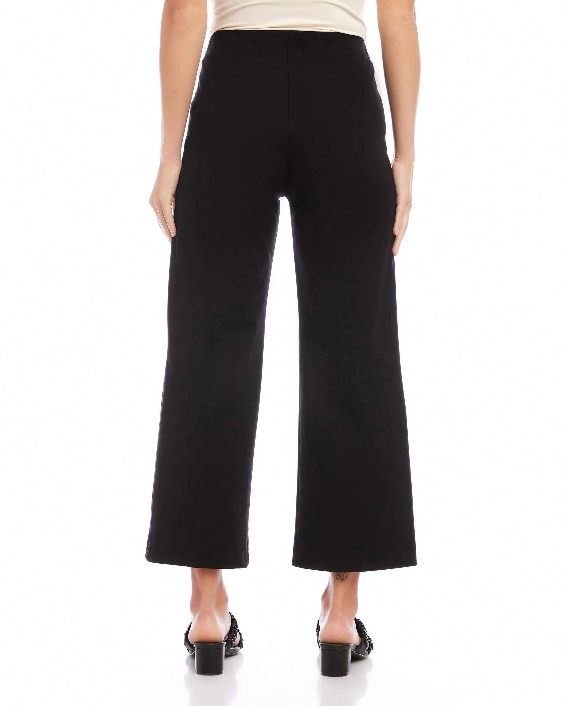 Back view of model wearing the Fifteen Twenty Wide-Leg Cropped Pant in black in front of a white background