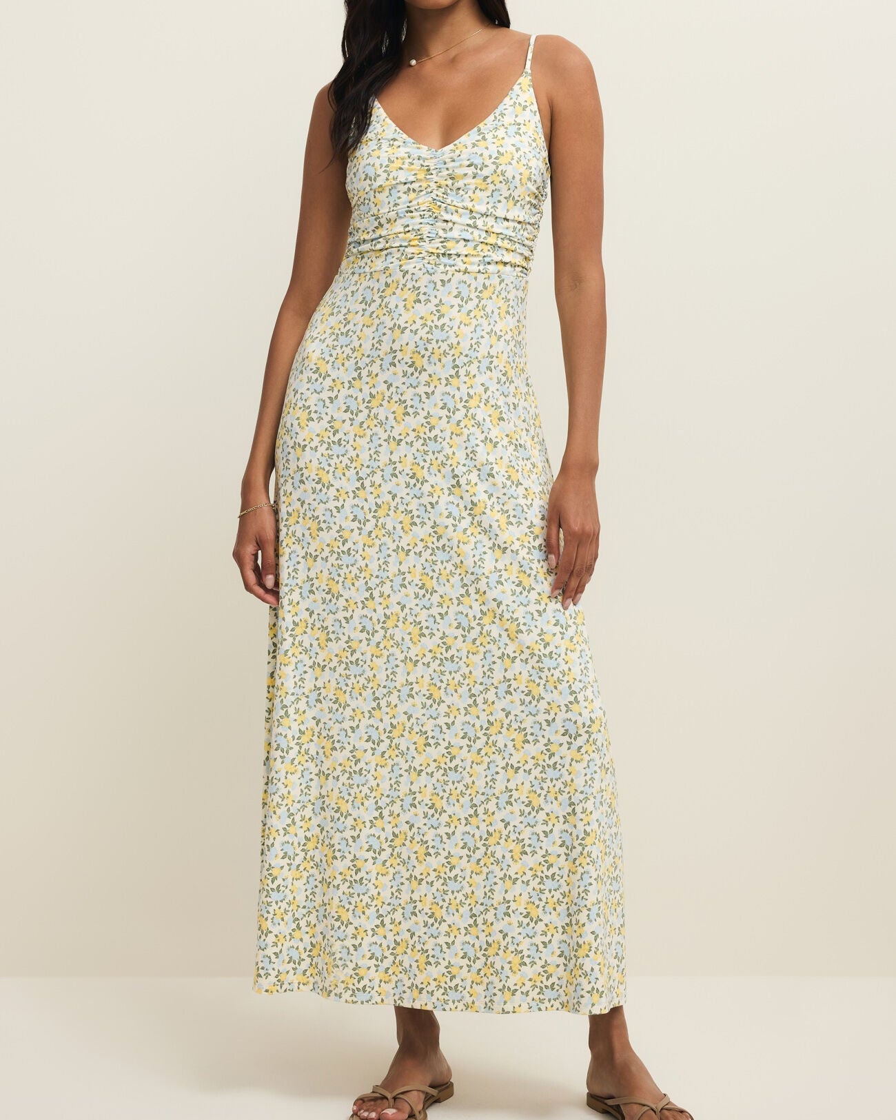 Woman wearing a floral dress on a plain background