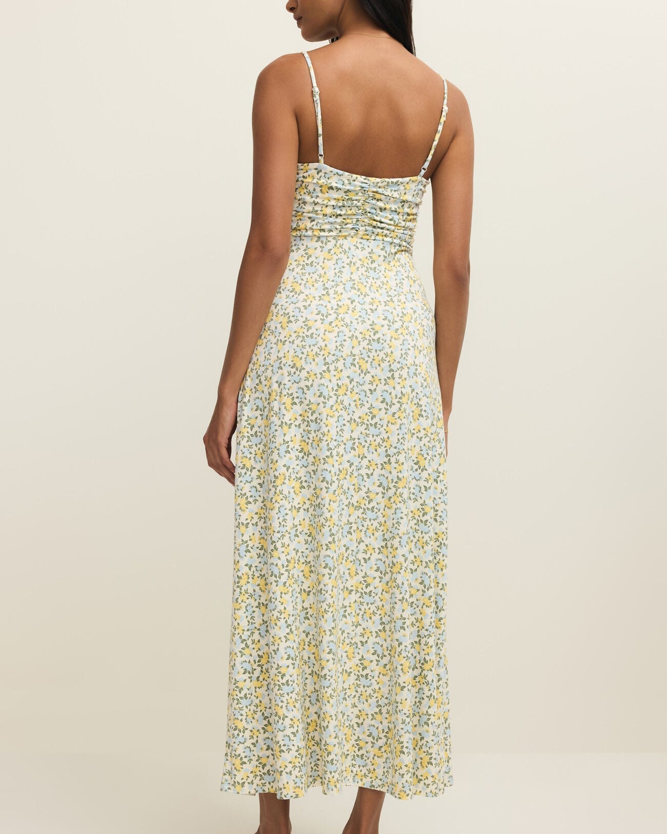 Woman wearing a floral dress on a plain background
