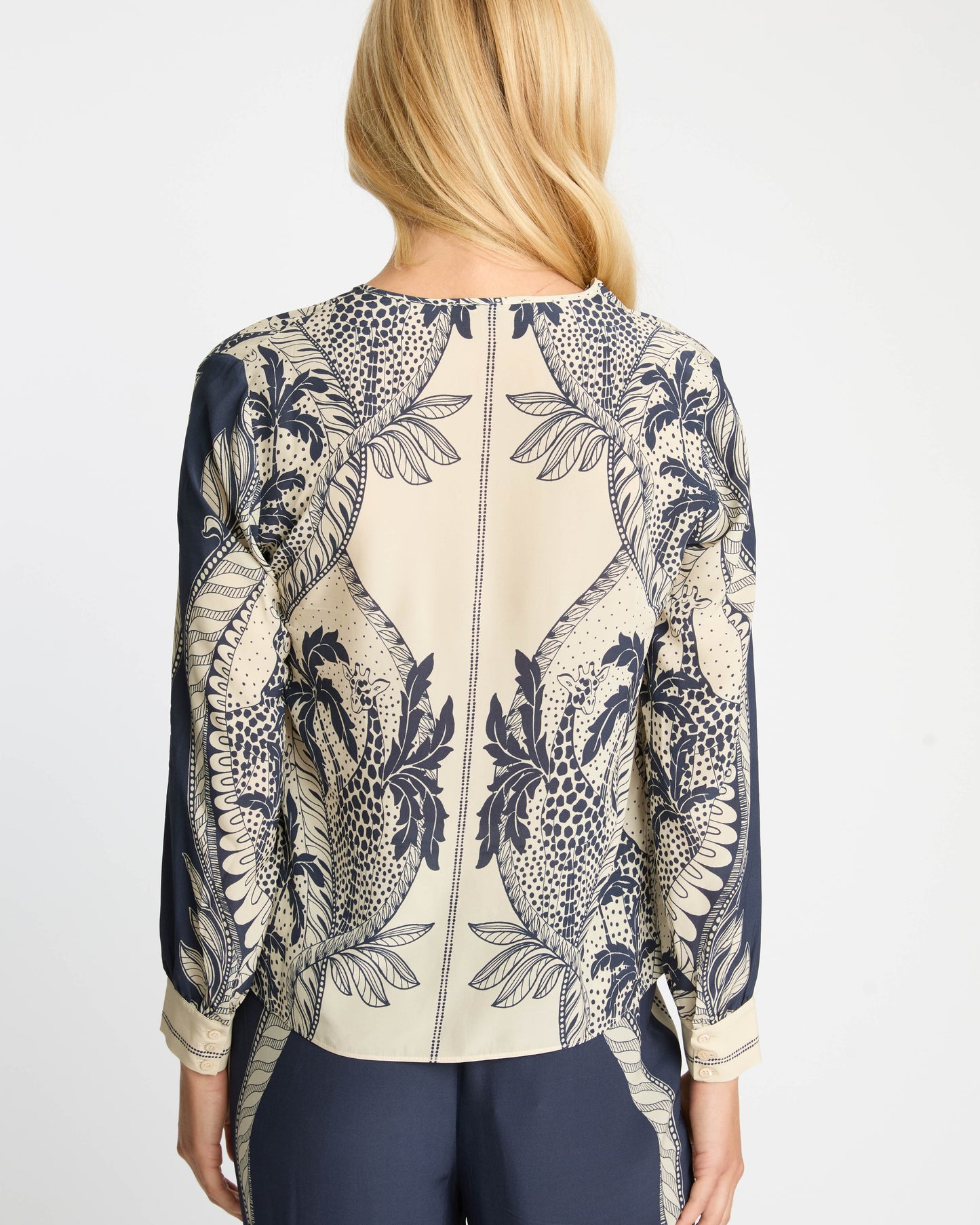 Woman wearing a patterned blouse with a white background