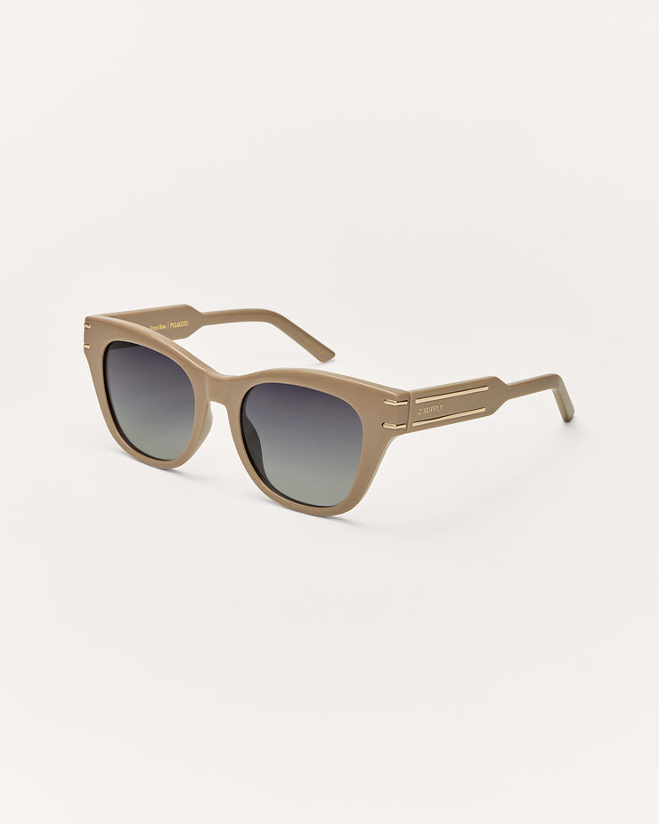 Beige sunglasses with gradient lenses on a white background