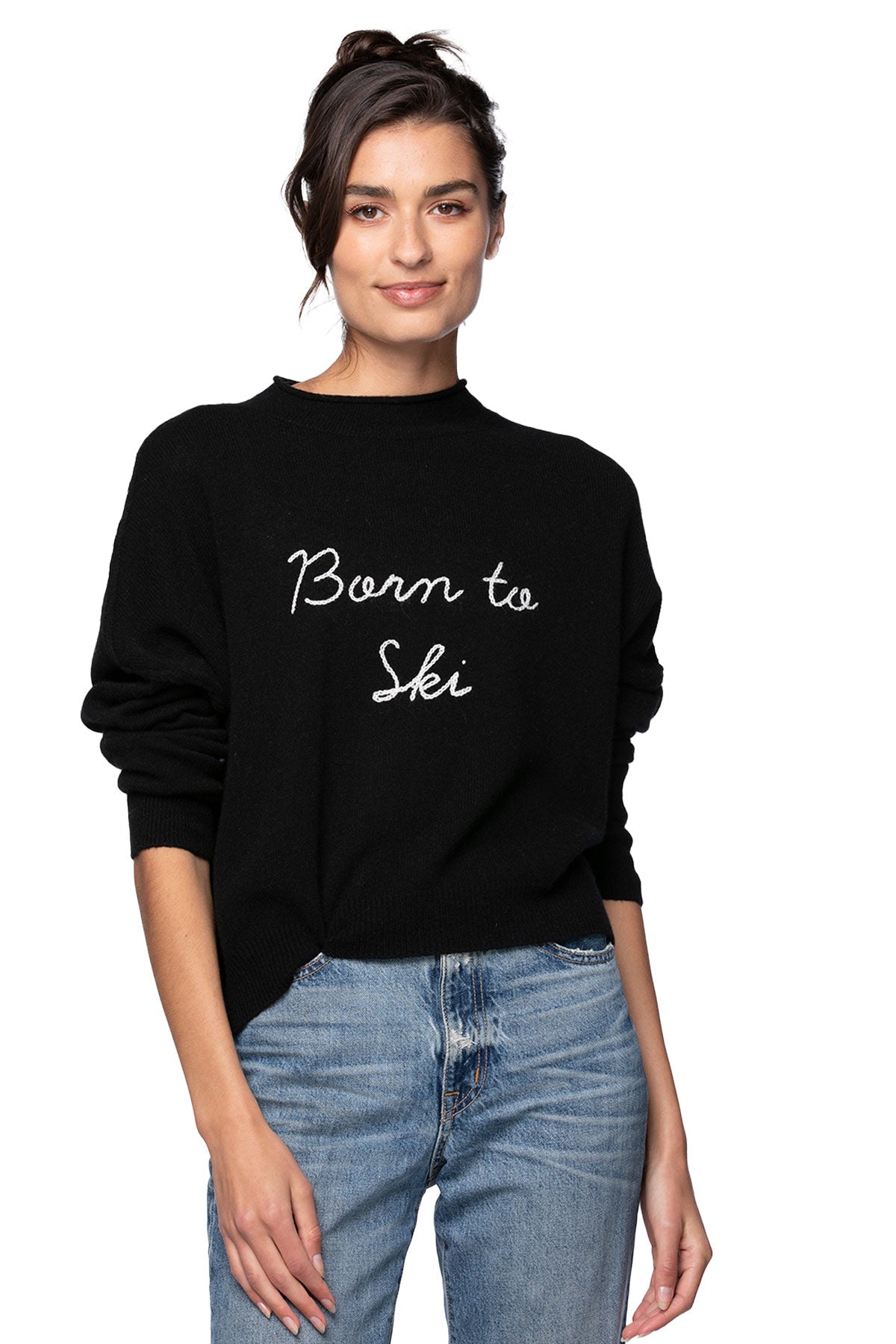 Model wearing Golden Sun Born to ski cashmere funnel neck sweater wearing jeans on a white background
