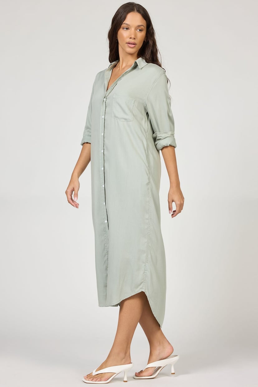 Woman wearing a light green dress on a white background