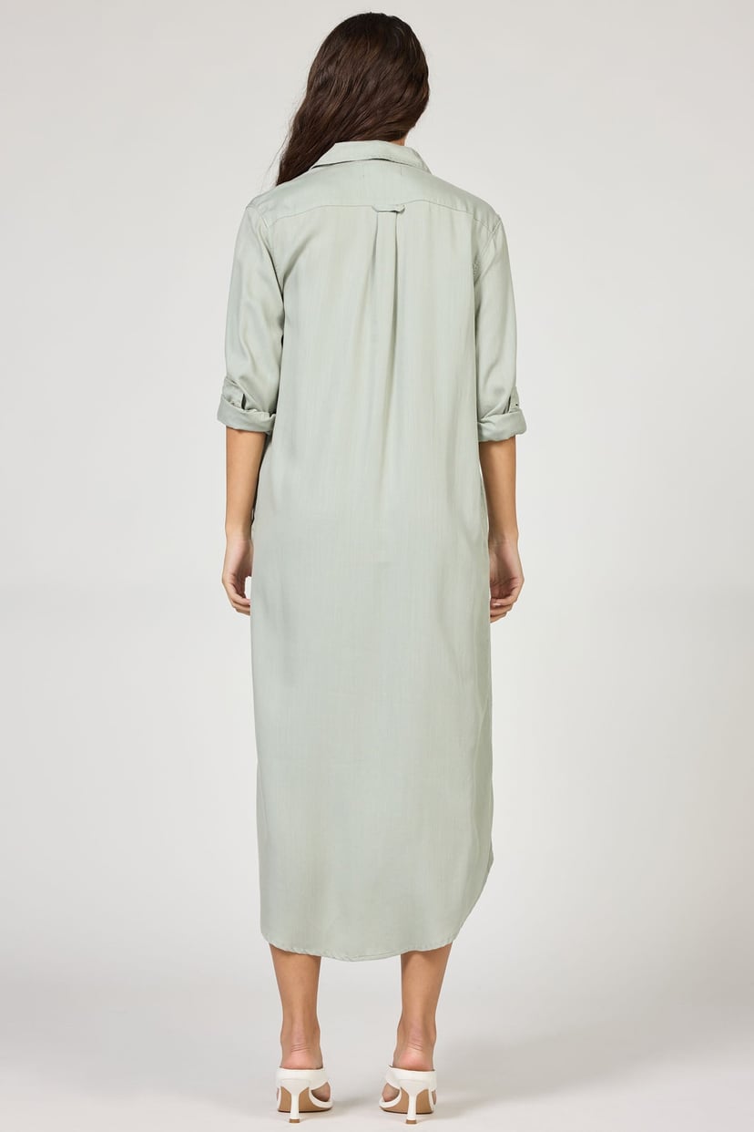 Woman wearing a light green dress on a white background