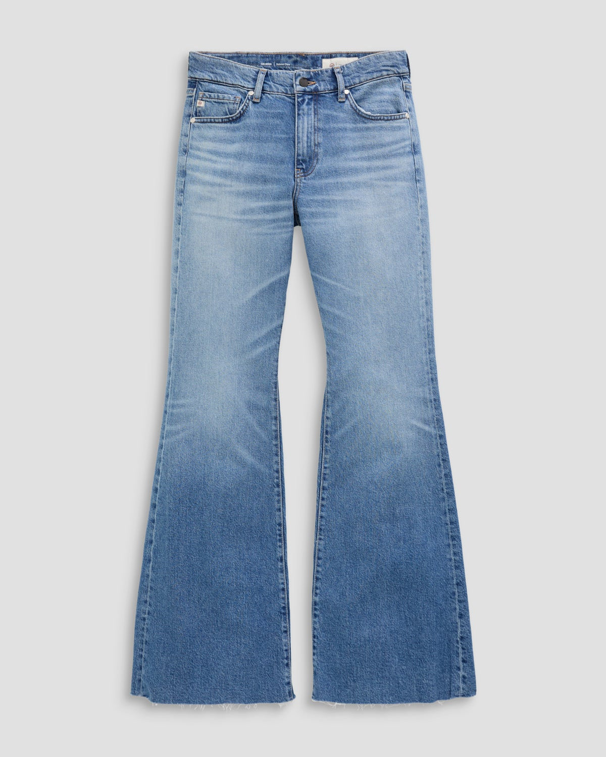 Blue flared jeans on a light gray background