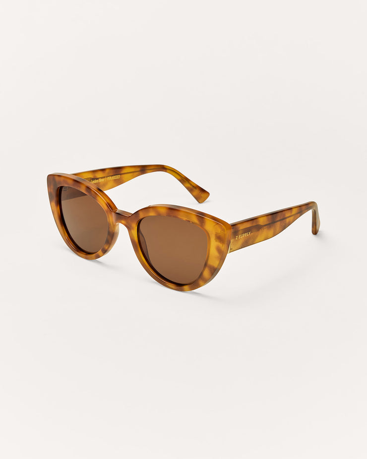 Tortoiseshell sunglasses with brown lenses on a white background