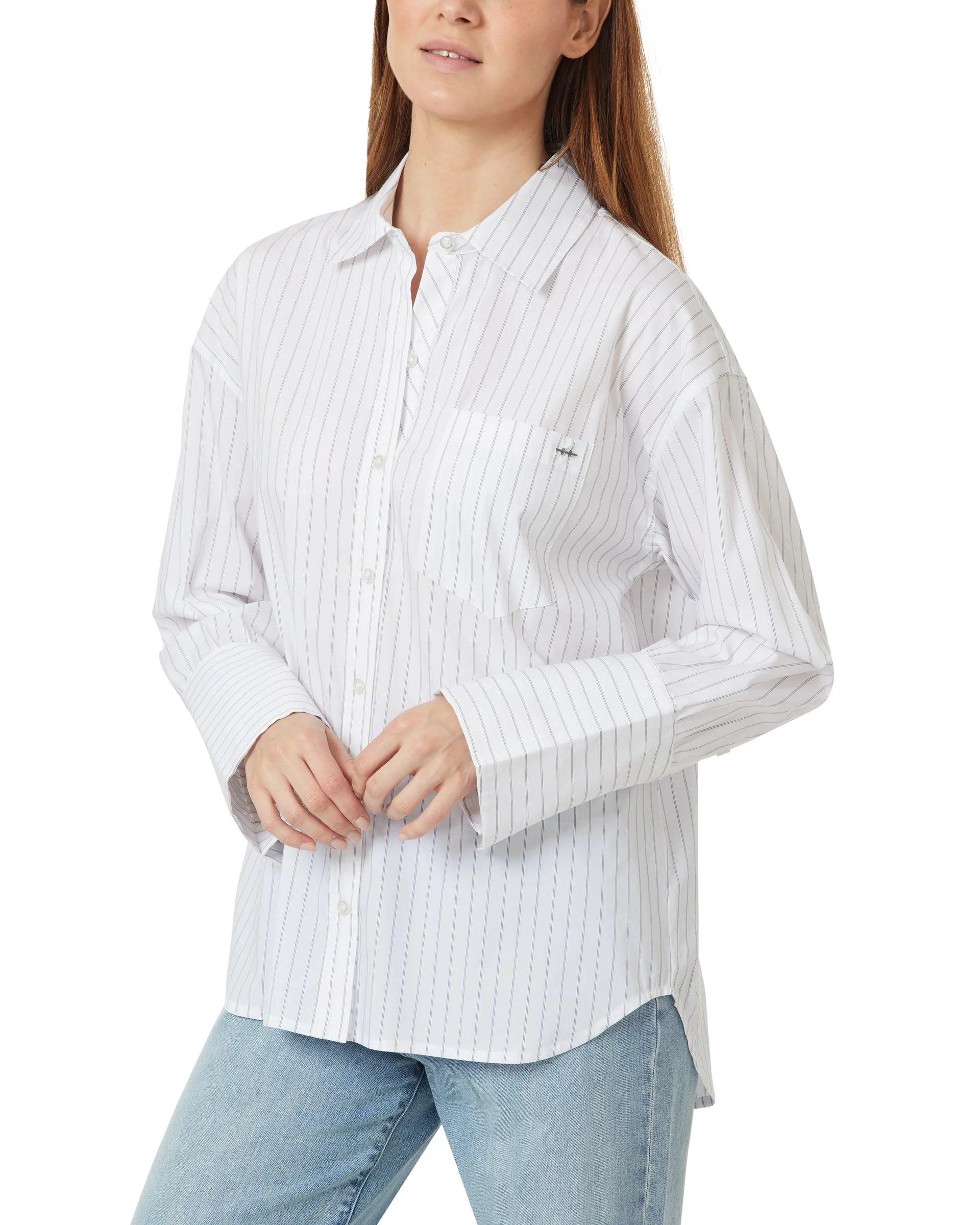 Woman wearing a white striped shirt and light blue jeans on a white background