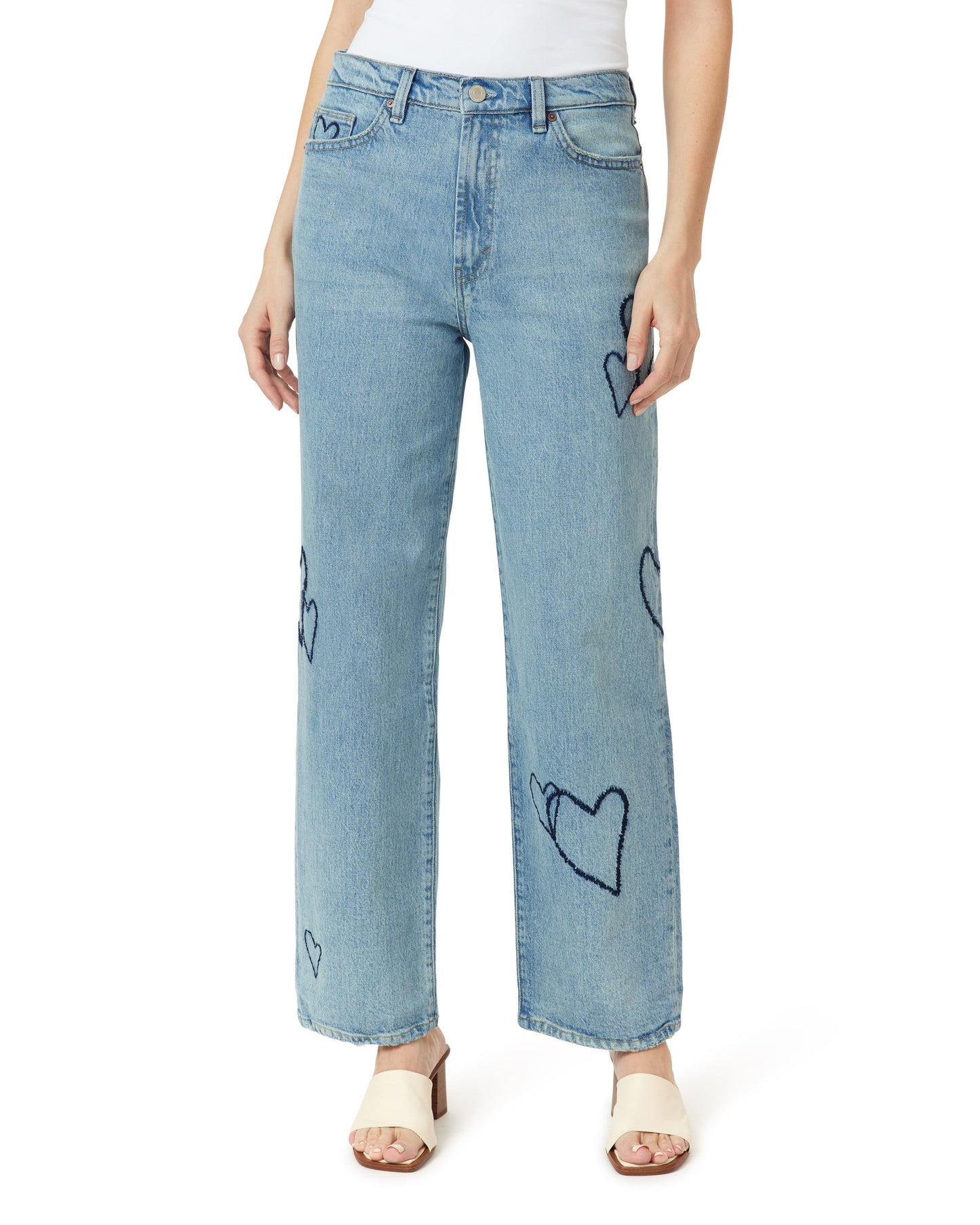 Light blue jeans with black heart patterns worn by a person on a white background
