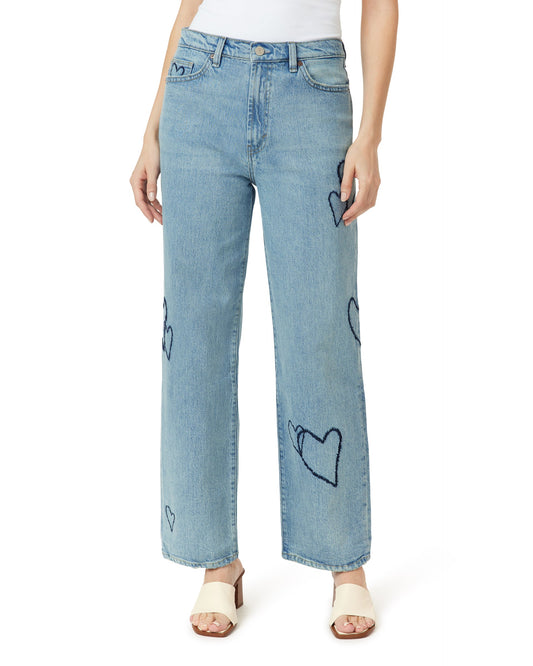 Light blue jeans with black heart patterns worn by a person on a white background