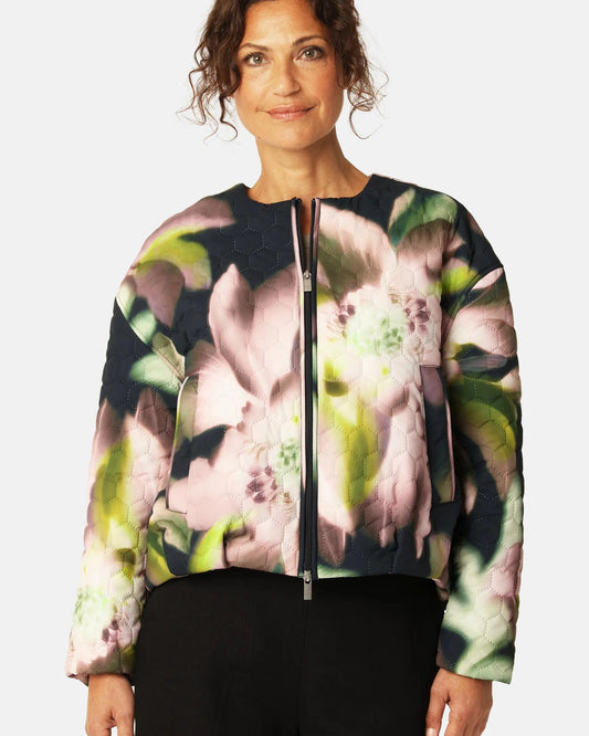 Woman wearing a floral-patterned jacket on a white background