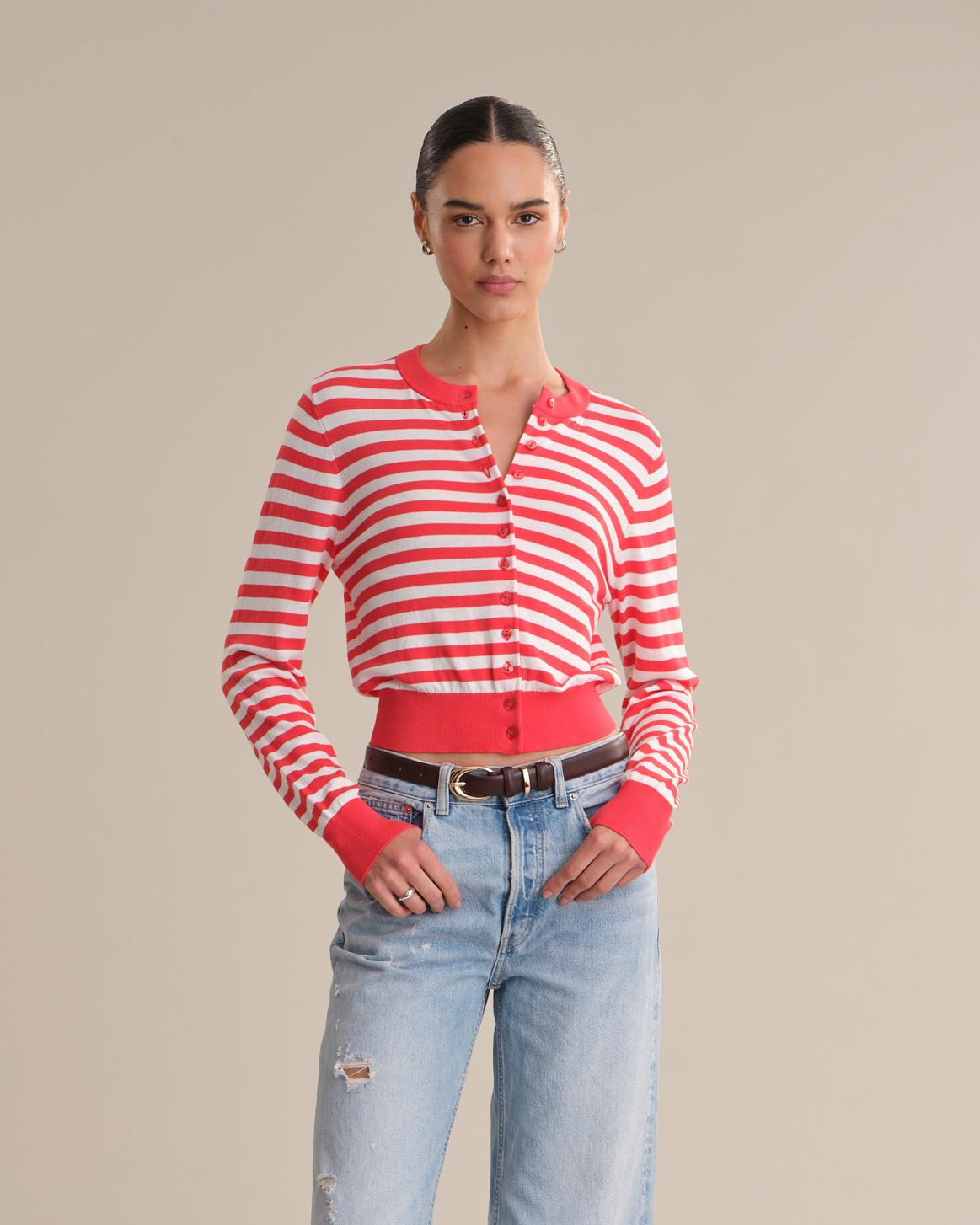 Woman wearing a red and white striped shirt with a plain background