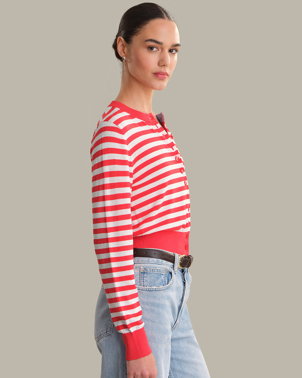 Person wearing a red and white striped sweater with a gray background